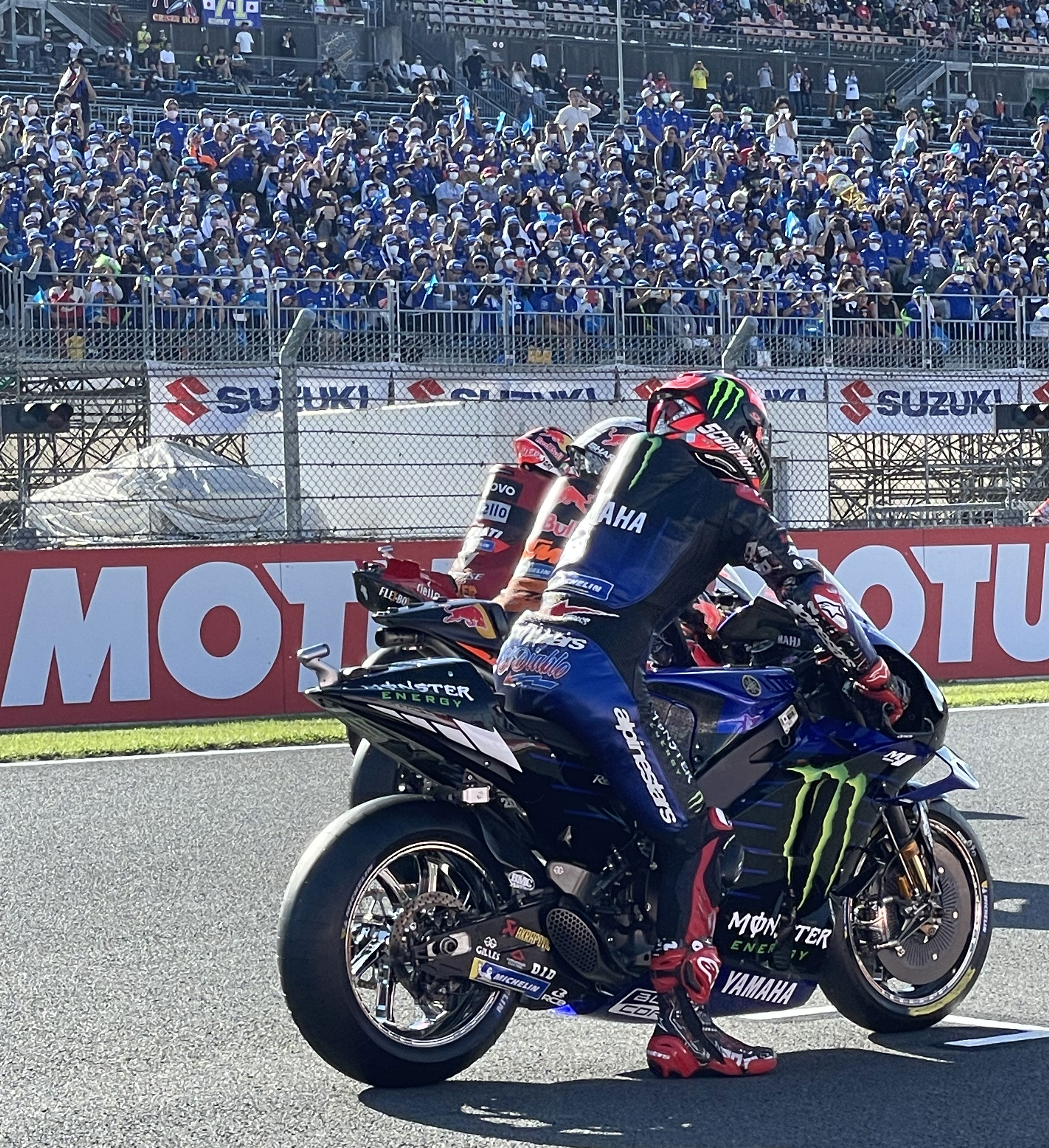 MotoGPの現場でチームが勝利を分かち合う様子